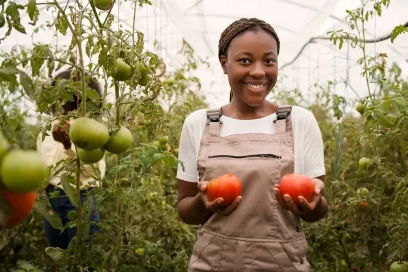 Smiling farmer holding agricultural produce from her farm - Agrosahas