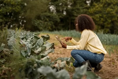A woman in her phone using technology on the farm