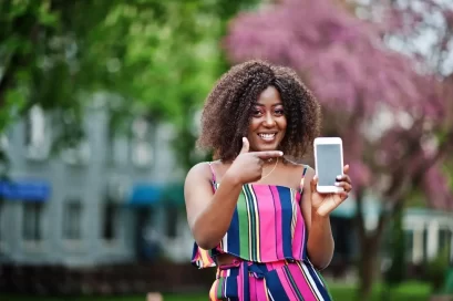 Smiling lady shows off her digifarmer app on her smart phone